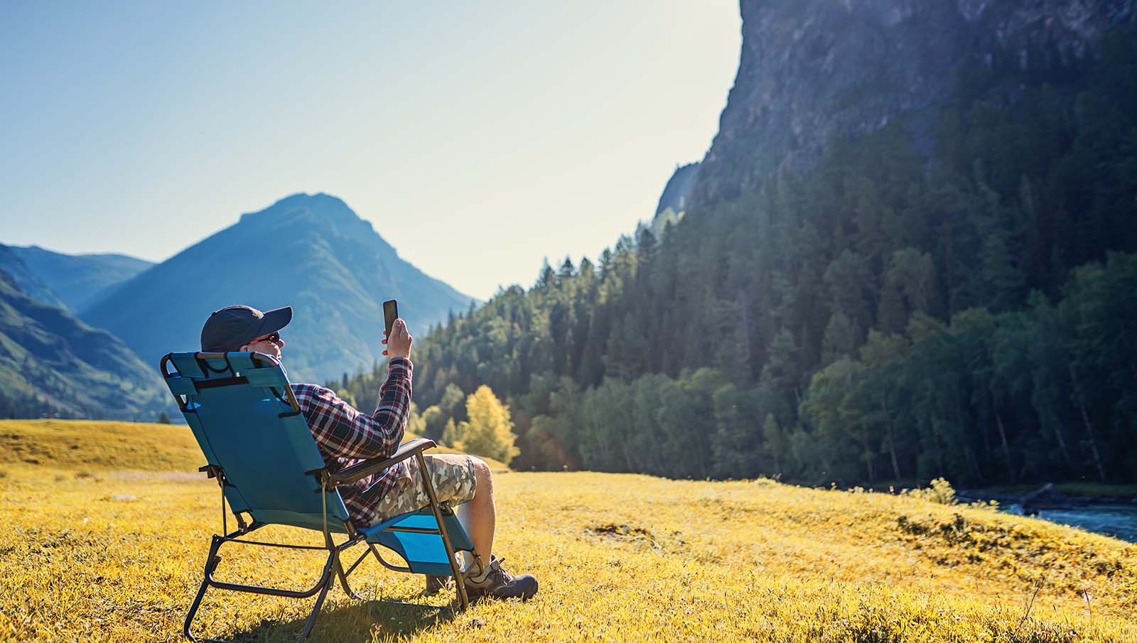 Elderly man using cellphone outdoors