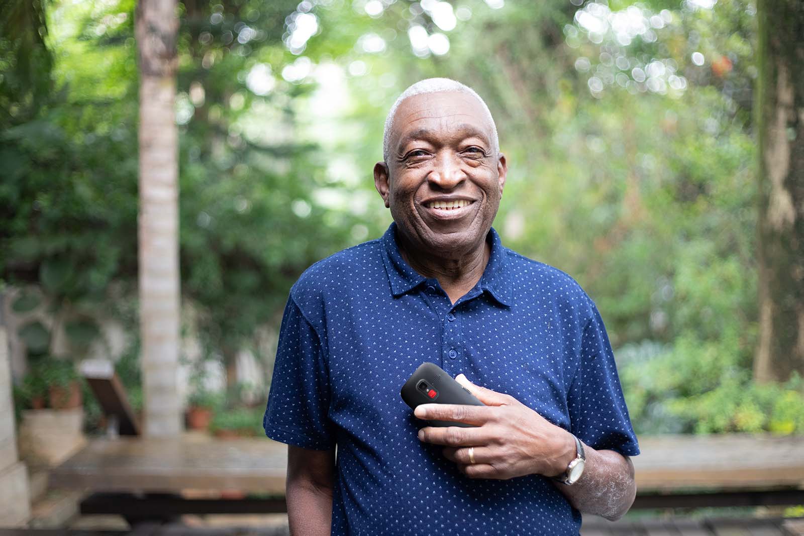 Elderly man holding cellphone