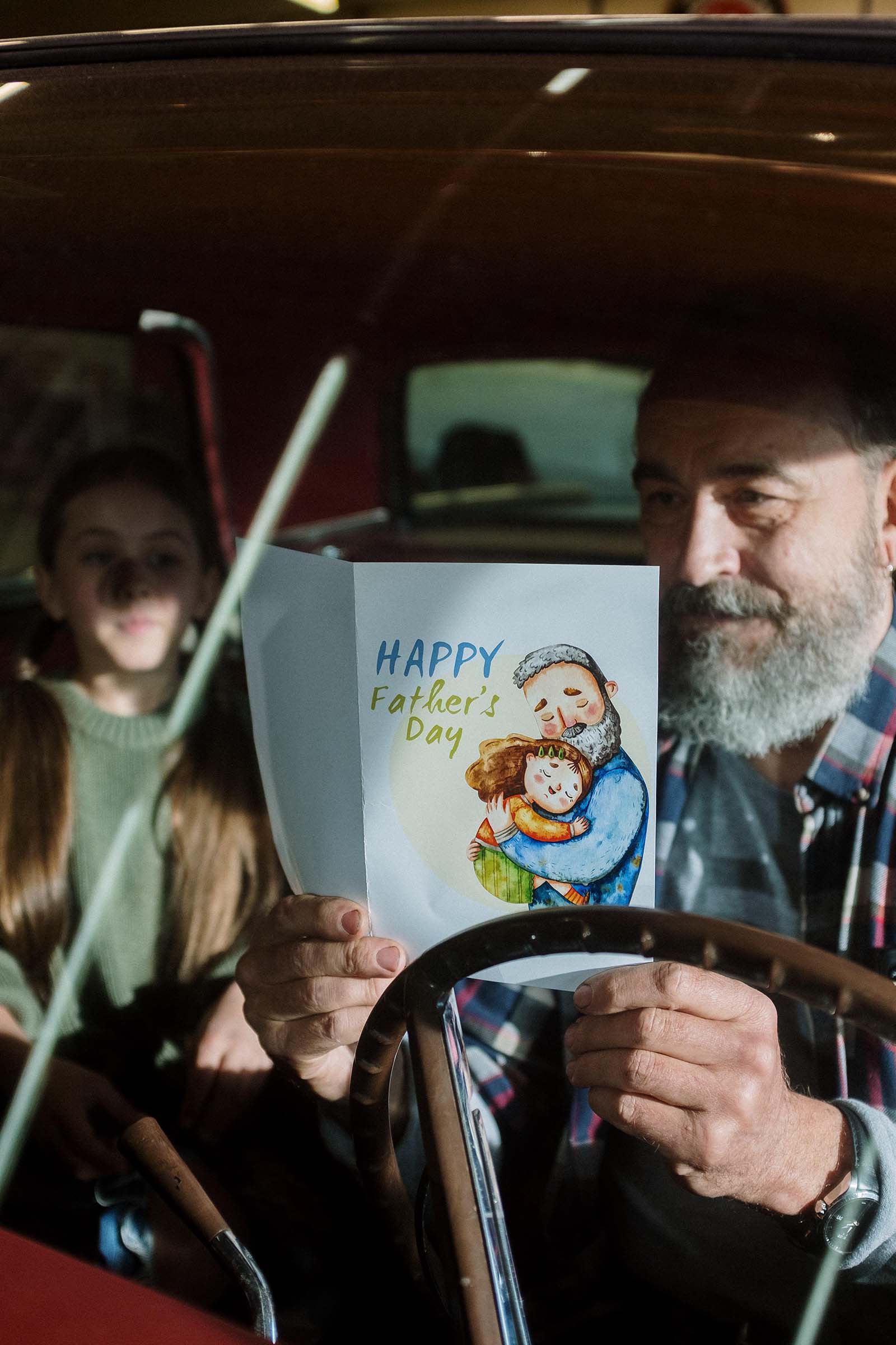 Father reading Father's Day card from his daughter